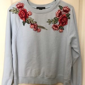 Baby blue sweatshirt with flower patches